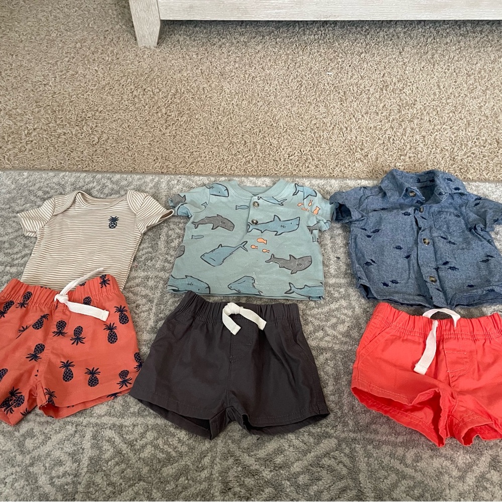 Three Hawaiian style sets by Carter's in a size newborn.